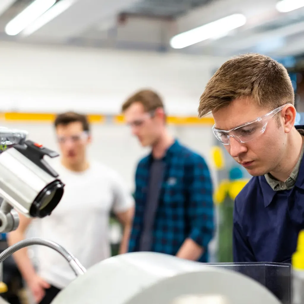 persons wearing safety glasses in factory environment