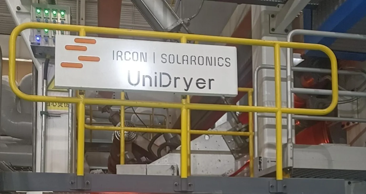 Ircon-Solaronics UniDryer sign mounted on industrial equipment with yellow safety rail.